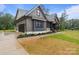Stylish home exterior with a modern color scheme, featuring an attached garage and beautifully landscaped front yard at 153 Mills Garden Rd, Statesville, NC 28625