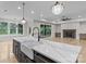Open-concept kitchen with a large island, marble countertops, stainless steel appliances, and seamless flow to living area at 153 Mills Garden Rd, Statesville, NC 28625