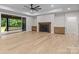Bright living room featuring a cozy fireplace, ample natural light, and a seamless transition to outdoor space at 153 Mills Garden Rd, Statesville, NC 28625