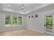 Light-filled room with large windows and a door to the outdoor patio, offering a peaceful view of lush greenery at 153 Mills Garden Rd, Statesville, NC 28625