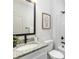 Bathroom with light granite countertop, dark fixtures, and a tub/shower with a white shower curtain at 1604 N Main St, Mount Holly, NC 28120