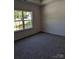 A bright bedroom with large windows, plush carpeting, and ample natural light creates a cozy atmosphere at 1604 N Main St, Mount Holly, NC 28120