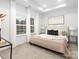 Bright bedroom with tray ceiling, plush carpet, two windows, and neutral walls and bedding at 1604 N Main St, Mount Holly, NC 28120
