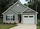 Charming single-story home with gray siding, black shutters, and an attached one-car garage at 1604 N Main St, Mount Holly, NC 28120