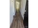 Entry hallway with beautiful, durable wood flooring and neutral walls leading to the rest of the home at 1604 N Main St, Mount Holly, NC 28120
