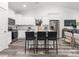 Bright open-concept kitchen featuring white cabinets, stainless steel appliances, and a large island with seating at 1604 N Main St, Mount Holly, NC 28120