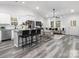 Open-concept living space features modern furnishings, lots of windows, and seamless access to a gourmet kitchen at 1604 N Main St, Mount Holly, NC 28120