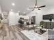 Sunlit open-concept living area with neutral color scheme and views into a white kitchen and stainless appliances at 1604 N Main St, Mount Holly, NC 28120