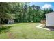 Expansive backyard with lush green grass, mature trees, and storage shed at 161 Crystal Bay Dr, Mooresville, NC 28115