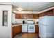 Efficient kitchen with wood cabinets, essential appliances, and ample counter space at 161 Crystal Bay Dr, Mooresville, NC 28115