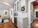 A butler's pantry features custom cabinets, a wine refrigerator, and a coffee machine at 161 Perrin Pl, Charlotte, NC 28207