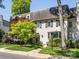 Charming home with stucco exterior, black shutters, and manicured landscaping at 161 Perrin Pl, Charlotte, NC 28207
