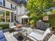 Landscaped patio features dark wrought iron furniture, stone tile and lush greenery at 161 Perrin Pl, Charlotte, NC 28207