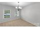 Bedroom featuring neutral walls, carpet flooring, two windows, and a modern chandelier at 1814 Tradd Ave, Clover, SC 29710
