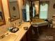 The bathroom features dual sinks, wallpaper, and a separate tub for relaxation at 1925 Mt Hope Church Rd, Salisbury, NC 28146