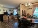 Open dining area with chandelier, wood floors, seamlessly connected to the living room at 1925 Mt Hope Church Rd, Salisbury, NC 28146