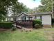 Charming single-story home with wood ramp, inviting front deck, and mature trees at 1925 Mt Hope Church Rd, Salisbury, NC 28146