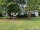 Landscaped front yard with swing set and charming single-story home, great curb appeal at 1925 Mt Hope Church Rd, Salisbury, NC 28146