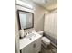Cozy bathroom features white vanity, modern fixtures, framed mirror and a shower with striped curtain at 1928 Londonberry Dr, Rock Hill, SC 29730