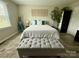 Bedroom features neutral tones, a cozy bench, and natural light from a window and some artwork at 1928 Londonberry Dr, Rock Hill, SC 29730