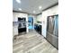 Modern kitchen features stainless steel appliances, white cabinets and light grey wood flooring at 1928 Londonberry Dr, Rock Hill, SC 29730