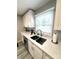 This bright kitchen features a stainless steel sink, window, grey backsplash, and white countertops at 1928 Londonberry Dr, Rock Hill, SC 29730