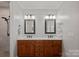 Elegant bathroom features double sinks, granite countertop, and decorative mirrors at 19679 Wooden Tee Dr, Davidson, NC 28036