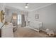 Bedroom with crib, chair, and accent shelves at 19679 Wooden Tee Dr, Davidson, NC 28036