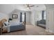 Bright bedroom with light gray walls, a toddler bed, a crib, and a large window at 19679 Wooden Tee Dr, Davidson, NC 28036