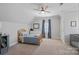Serene bedroom with light gray walls, a cozy bed, and soft blue accents and large windows at 19679 Wooden Tee Dr, Davidson, NC 28036