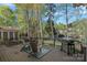 Enjoy outdoor living on this home's wooden deck featuring a grill and views of the backyard at 19679 Wooden Tee Dr, Davidson, NC 28036