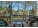 Relax on this deck with seating, a table, and a view of the spacious backyard at 19679 Wooden Tee Dr, Davidson, NC 28036