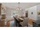 Dining room with modern lighting, view to entry and hardwood floors, creating an inviting atmosphere at 19679 Wooden Tee Dr, Davidson, NC 28036