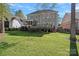 View of the home's backyard showing the deck, screened porch and landscaped yard at 19679 Wooden Tee Dr, Davidson, NC 28036