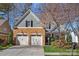 Charming home featuring a stone facade, two-car garage, and lush landscaping in a desirable neighborhood at 19679 Wooden Tee Dr, Davidson, NC 28036