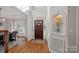 Bright foyer featuring hardwood floors, a decorative niche, and a view of the dining room at 19679 Wooden Tee Dr, Davidson, NC 28036