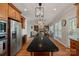 Gourmet kitchen with stainless steel appliances and large center island that is open to the living room at 19679 Wooden Tee Dr, Davidson, NC 28036