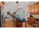 Open kitchen with center island that features modern lighting that flows into the living room at 19679 Wooden Tee Dr, Davidson, NC 28036