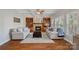 Beautiful living room with a cozy fireplace and built-in bookshelves, perfect for relaxing at 19679 Wooden Tee Dr, Davidson, NC 28036
