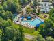 Aerial view of a resort-style pool with lap lanes, lounge chairs, and a play area at 19679 Wooden Tee Dr, Davidson, NC 28036