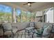 Relaxing sunroom features cozy seating with screened windows providing serene views of the outdoors at 19679 Wooden Tee Dr, Davidson, NC 28036