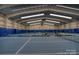 Indoor tennis court with professional lighting and ample space for players at 19679 Wooden Tee Dr, Davidson, NC 28036
