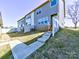 View of the backyard of a gray sided home, featuring a grassy area, and a small back porch at 2001 Laurel Village Cir, Belmont, NC 28012