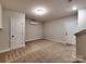 Finished basement with plush carpeting, neutral walls, and access to another level at 2001 Laurel Village Cir, Belmont, NC 28012