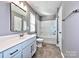 Bright bathroom with a single sink vanity, toilet, and a tub with shower at 2001 Laurel Village Cir, Belmont, NC 28012