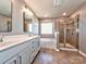 Modern bathroom featuring double vanity, a soaking tub, and separate shower at 2001 Laurel Village Cir, Belmont, NC 28012
