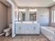 Stylish bathroom with double vanity, modern fixtures, and a separate tub at 2001 Laurel Village Cir, Belmont, NC 28012