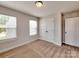 Comfortable bedroom featuring two bright windows, a double door closet, and neutral carpeting at 2001 Laurel Village Cir, Belmont, NC 28012