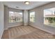 Inviting bedroom offering natural light from two windows with neutral walls and cozy carpeting at 2001 Laurel Village Cir, Belmont, NC 28012