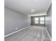 A bright bedroom features neutral gray walls, plush carpeting, and lots of natural light at 2001 Laurel Village Cir, Belmont, NC 28012